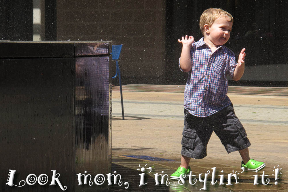 toddler playing at fountain